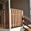 Veranda di legno con ringhiera e scale.