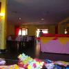 Interno di una sala ristorante con tavoli e decorazioni colorate.