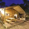 Una tenda da campeggio con area picnic, di sera.
