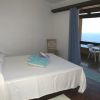 Camera da letto semplice con letto matrimoniale, finestra vista mare.