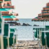 Ombrelloni verdi su spiaggia verso il mare.