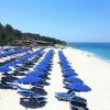 Ombrelloni blu su una spiaggia soleggiata.