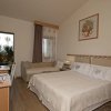 Camera d'hotel accogliente con letto matrimoniale e divano.