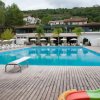 Piscina con scivolo per bambini e sedie a sdraio.
