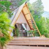 Tenda a forma di A immersa nella vegetazione.