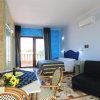 Camera con letto, divano, tavolo e balcone.