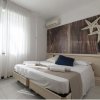 Camera con letto matrimoniale, decorazioni a forma di stelle marine, luce naturale.